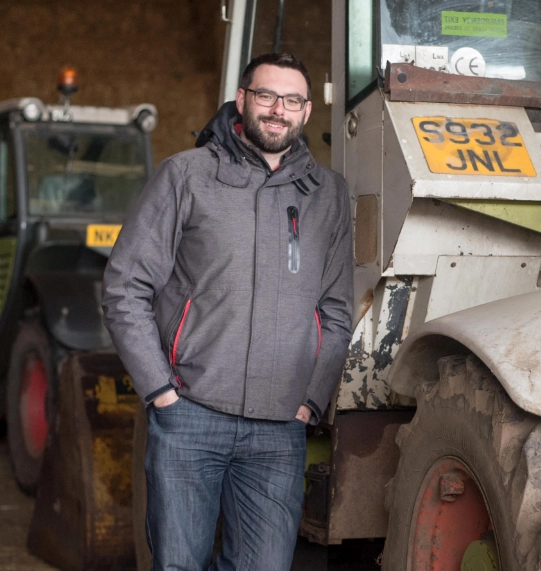 leaning on tractor